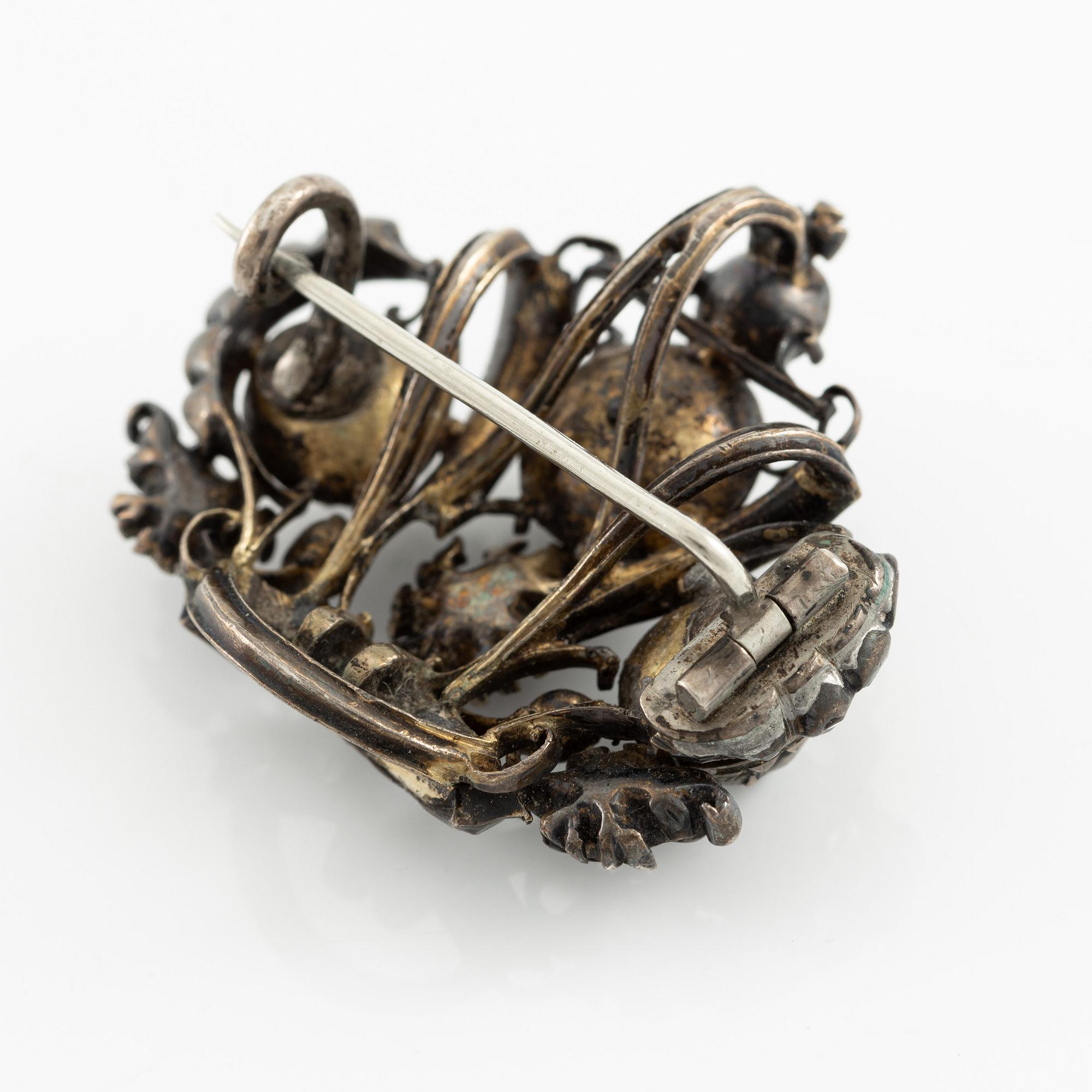A brooch, a brooch pin, and a pendant, likely 19th century.