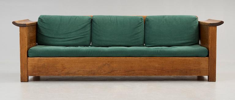 An Axel Einar Hjorth stained pine sofa 'Sandhamn', by Nordiska Kompaniet ca 1929.