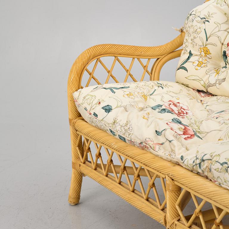 A rattan sofa and two armchairs, later part of the 20th century.