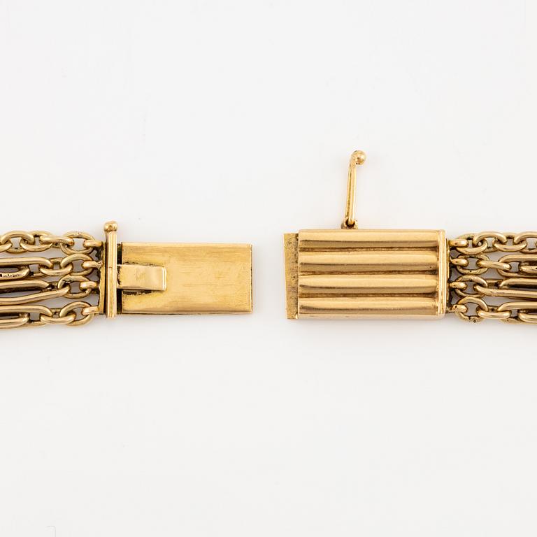 A W.A. Bolin necklace in 18K gold with pearls and white discs.