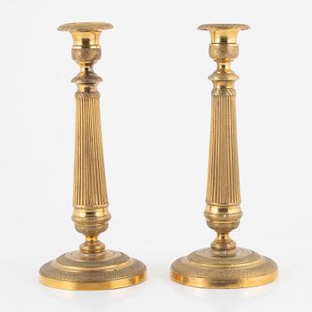 A pair of gilt brass Empire candlesticks, early 19th century.