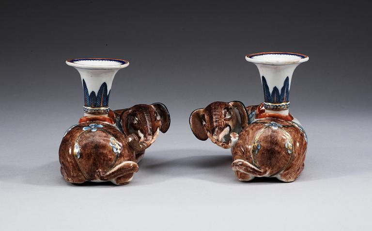 A pair of famille rose candlesticks in the shape of elephants, Qing dynasty, Qianlong (1736-95).