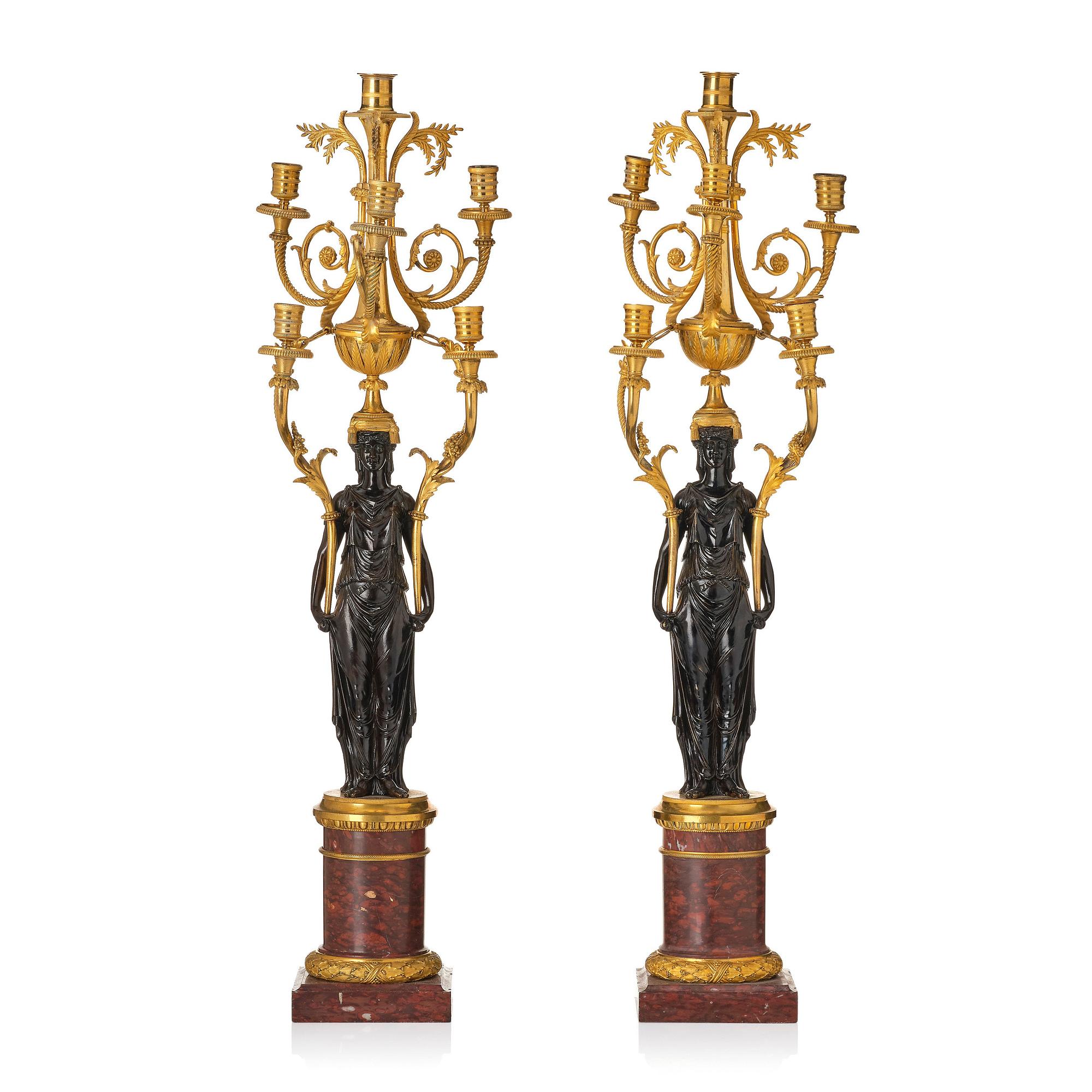 A pair of Louis XVI ormolu and patinated bronze six-branch candelabra attributed to François Rémond, late 18th century.