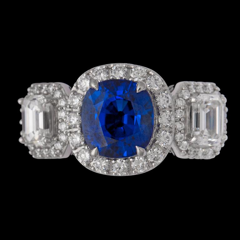 A cushion cut blue sapphire 3.06 cts, and emerald-and brilliant cut diamond ring.