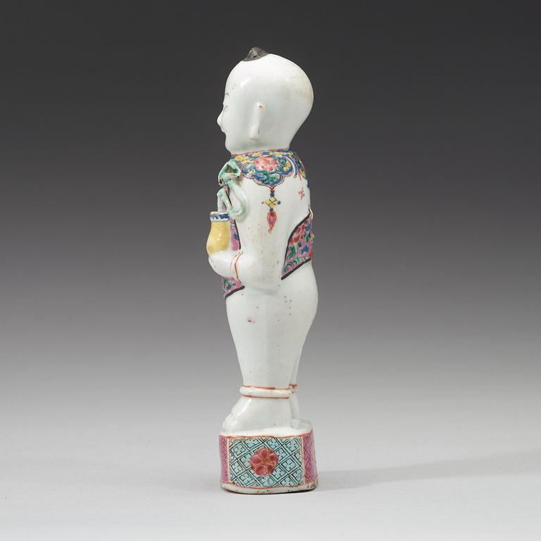 A famille rose figure of a boy, Qing dynasty, 18th Century.