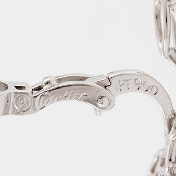 Cartier a pair of earrings platinum set with drop-shaped and round brilliant-cut diamonds.