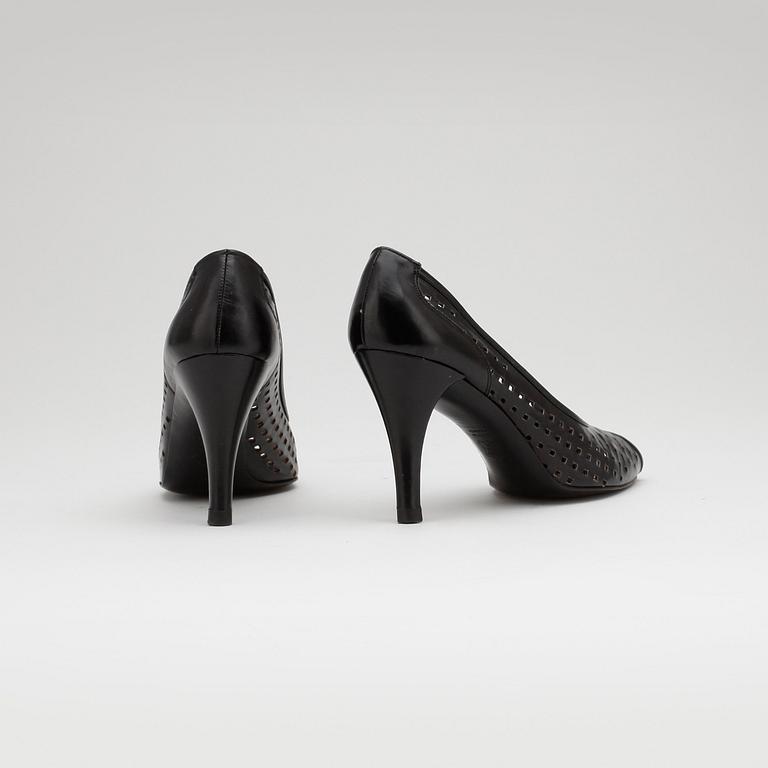 CHARLES JOURDAN, a pair of black leather pumps.