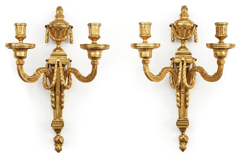 A pair of Louis XVI late 18th century gilt bronze two-light wall-lights.