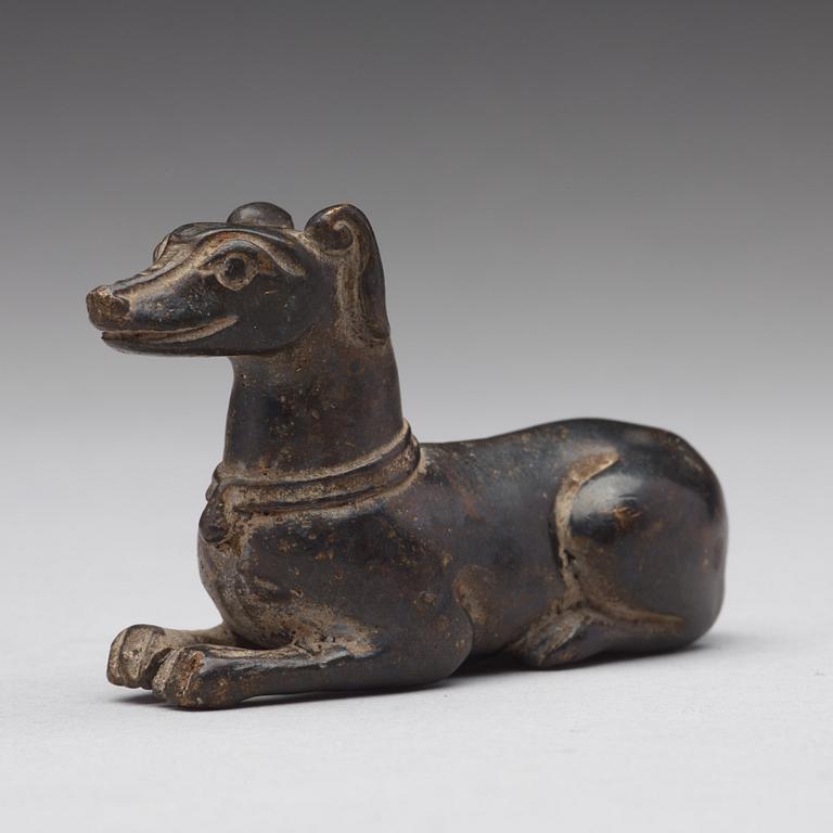 A bronze figure of a reclining dog, Ming dynasty (1368-1644).