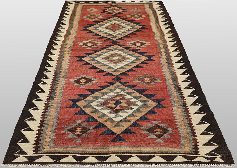 A Nomad Kurdish kilim rug, 270 x 132 cm.