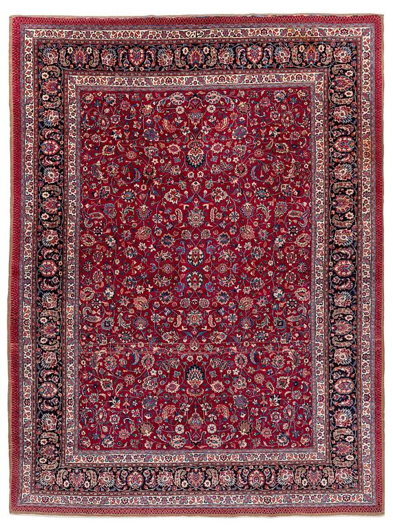 A Mashad carpet, signed Saber, c. 402 x 299 cm.