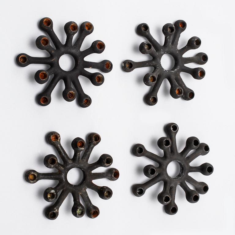Four 1960s iron cast candle holders, designed by Jens Quistgaard for Dansk Designs .