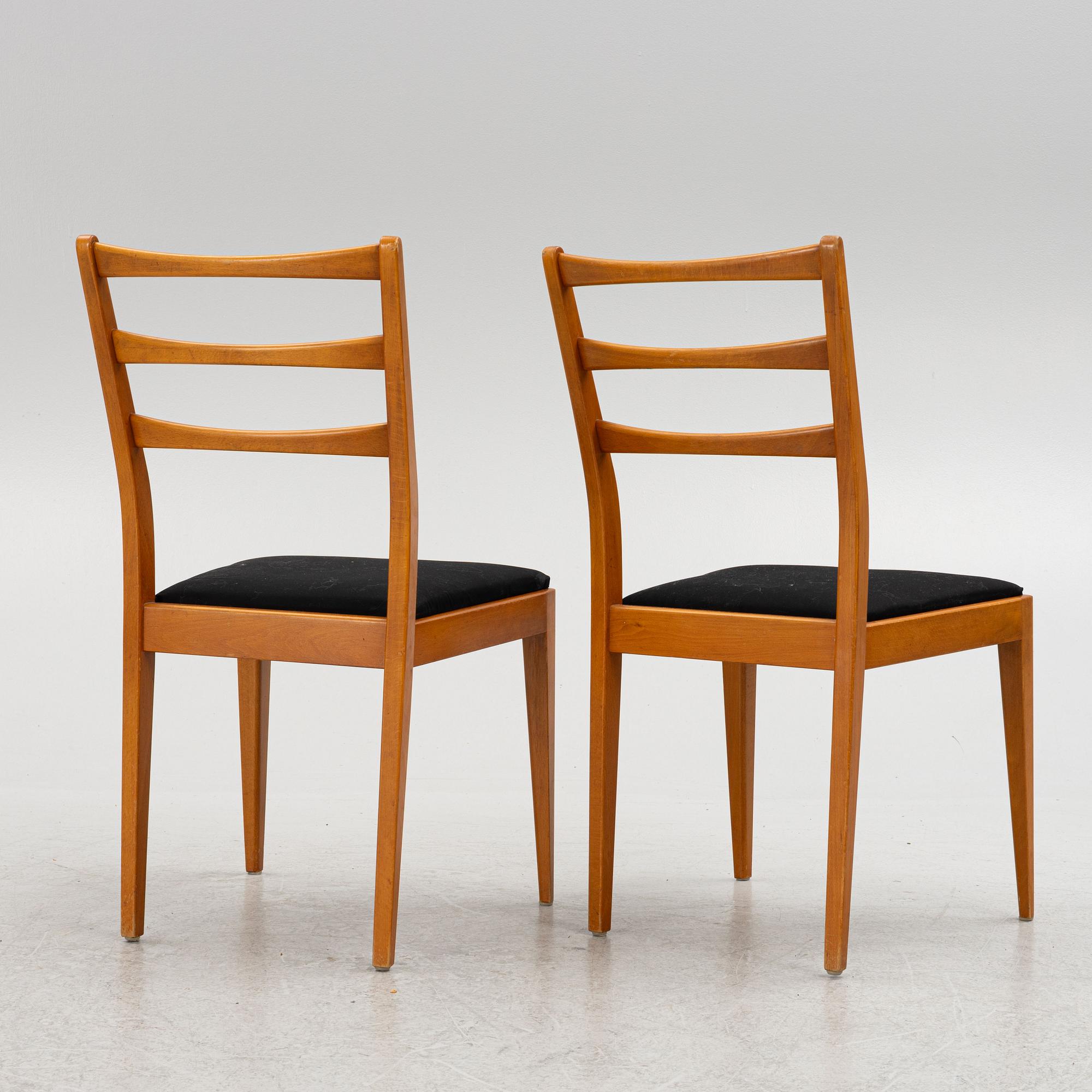 A dining table with four chairs, mid 20th century.