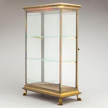 A brass and glass display cabinet, first half of the 20th Century.