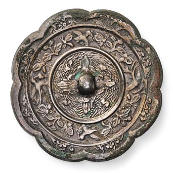 An eight lobed bronze mirror with a mythical bird design, Tang Dynasty (618—907).