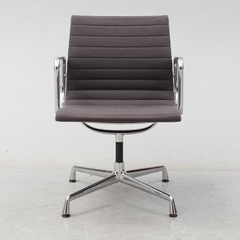 An 'EA 104 Swivel' armchair by Charles & Ray Eames, Vitra, 2007.