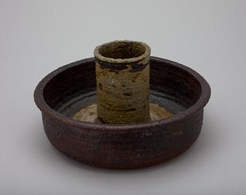 A CERAMIC CANDLESTICK.