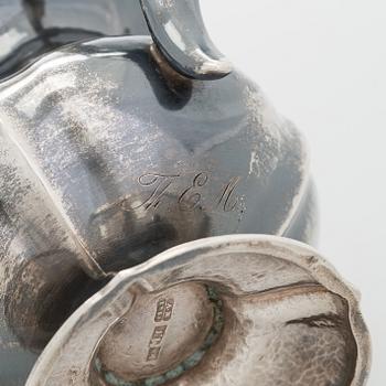 A silver cream jug, maker's mark of Michael Takkinen, St. Petersburg 1856.