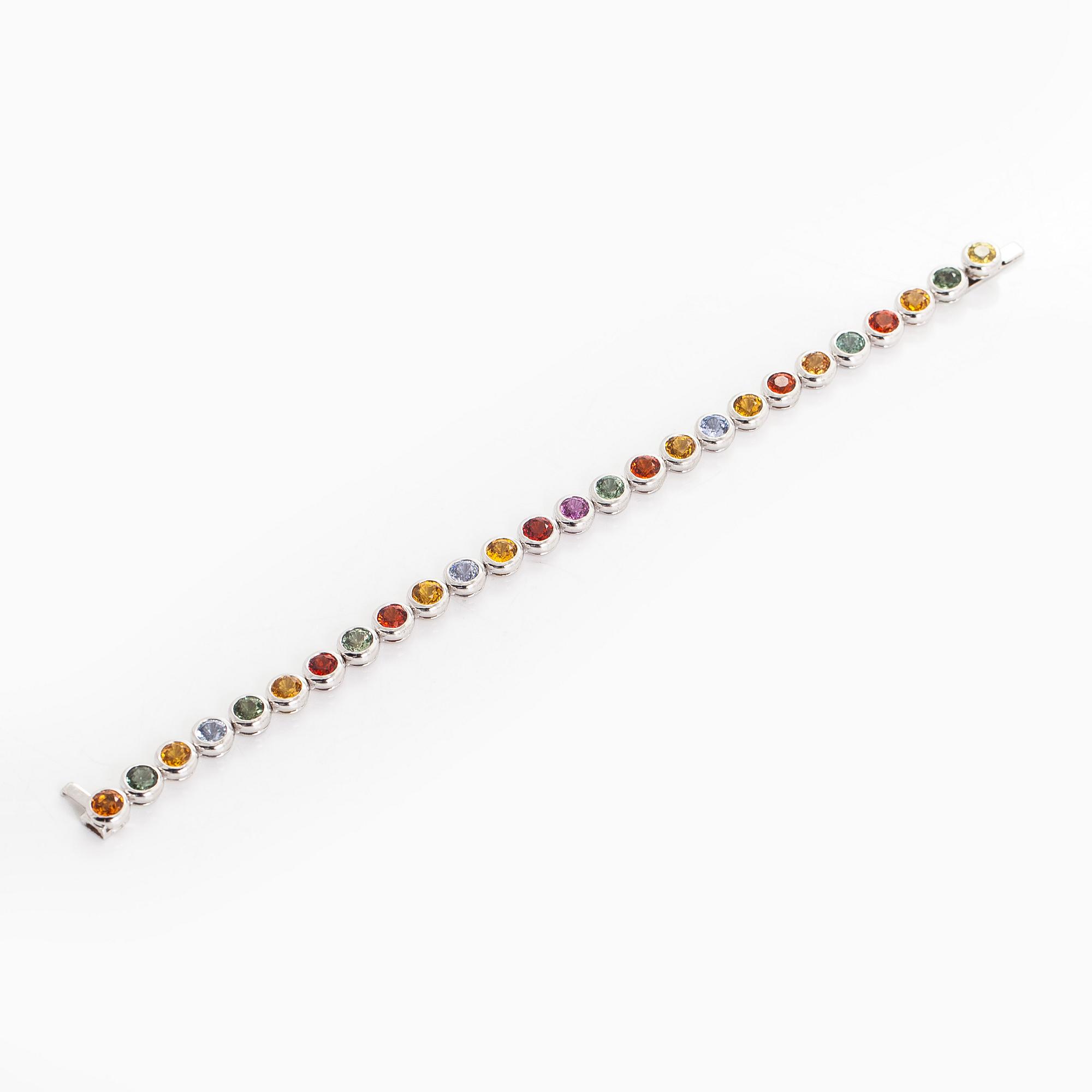An 18K white gold bracelet, set with multicoloured sapphires.