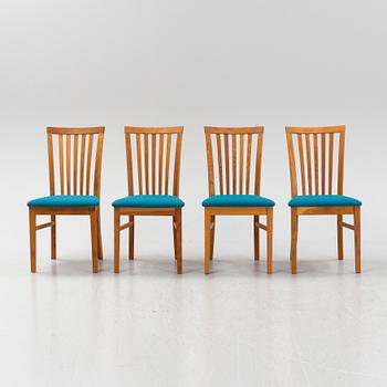 A set of four oak chairs from around the year 2000.