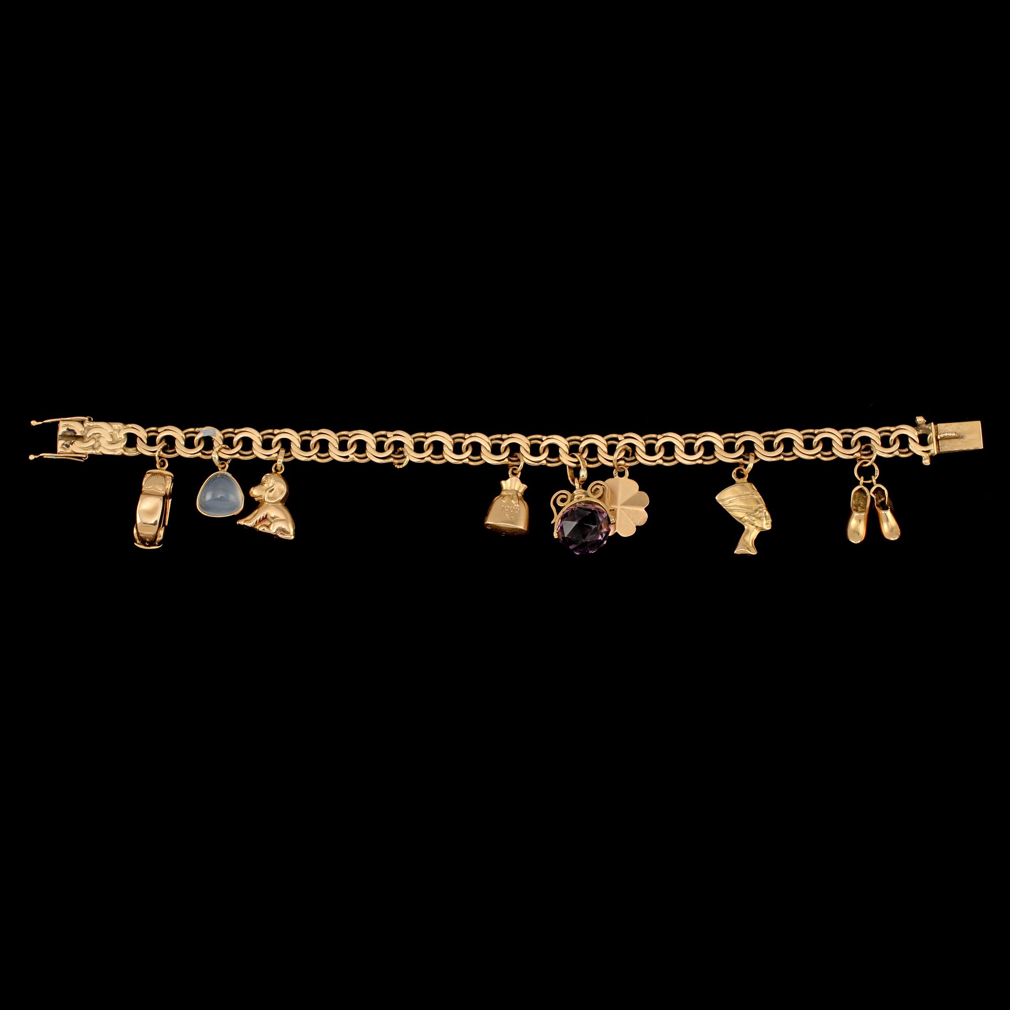 BERLOCKARMBAND, 18k guld med månsten och ametist, Gustav Dahlgren & Co, Malmö, 1963. Vikt 22 g.