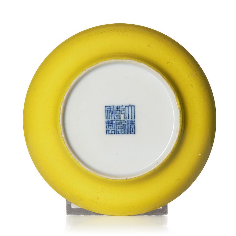 A yellow glazed dish, Qing dynasty with Qianlong mark and of the period (1736-95).