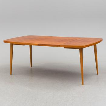 A 1950s teak and teak veneer table.
