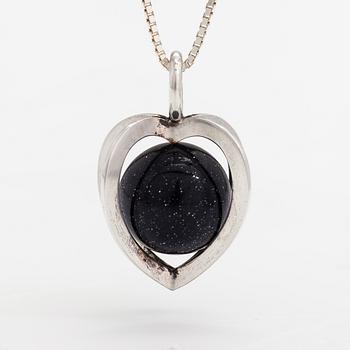 Elis Kauppi, A silver necklace with a purple goldstone. Kupittaan kulta, Turku.