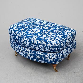 A pair of easy chairs and a stool.