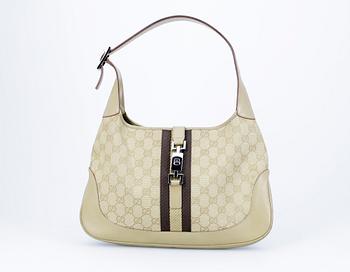 628. A beige monogram canvas handbag by Gucci.