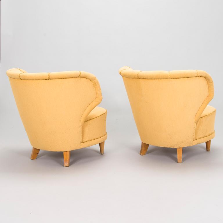 A pair of mid-20th century armchairs.