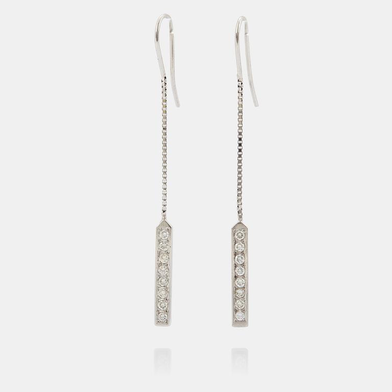 A pair of 18K white gold earrings set with round brilliant-cut diamonds.