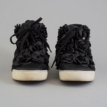 A black leather sneakers by Chanel.