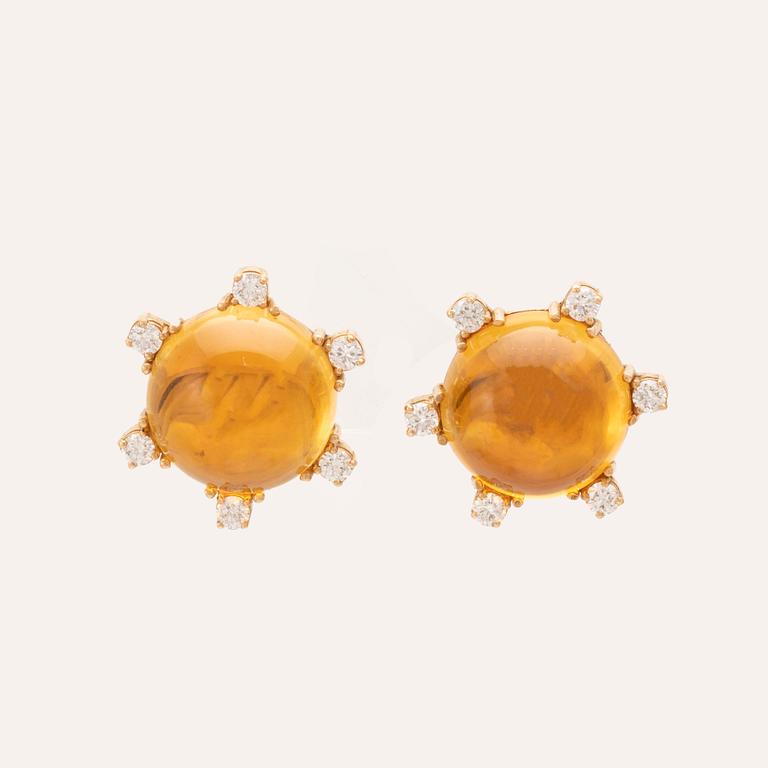 A pair of 18K gold earrings set with cabochon cut citrines and round brilliant cut diamonds.