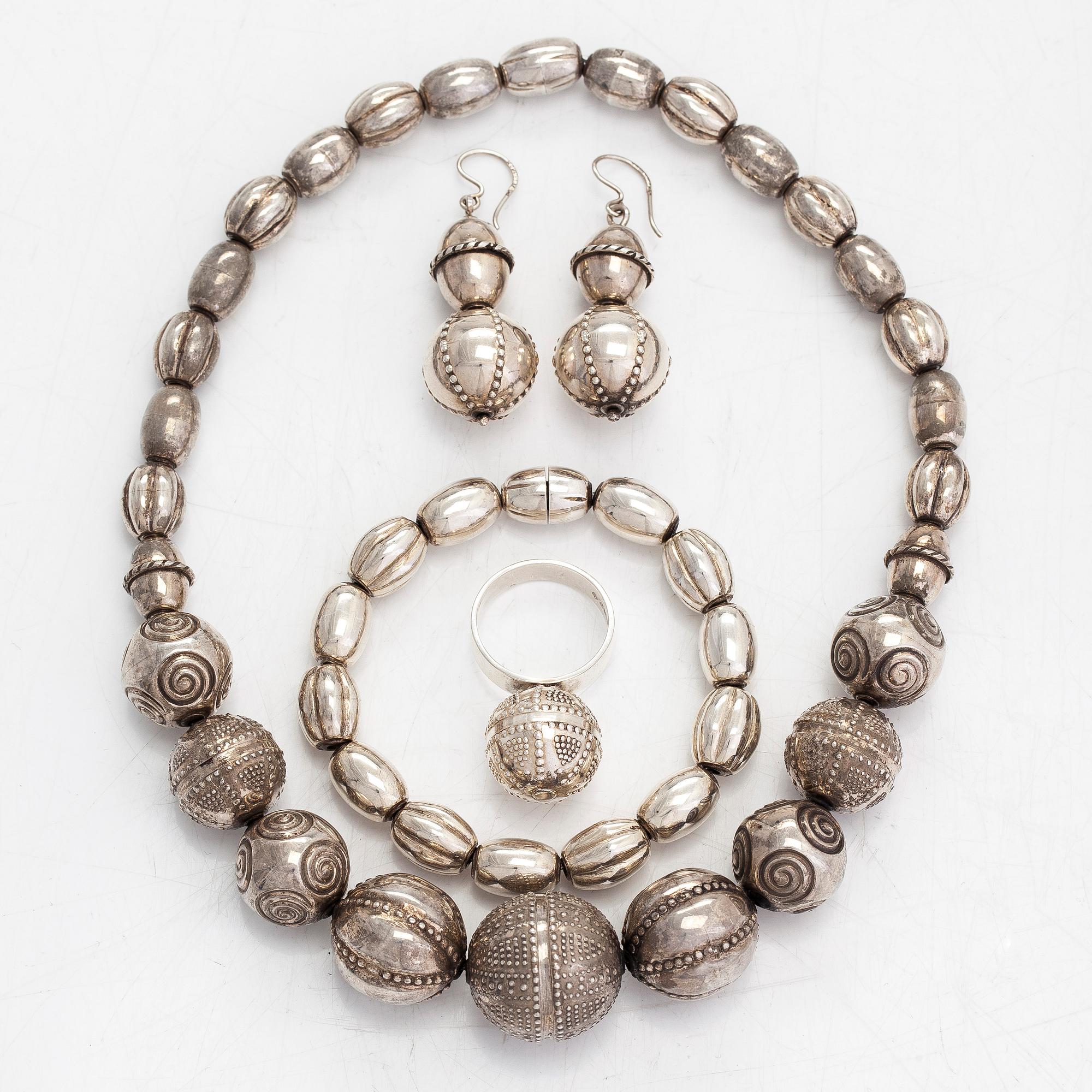 A set of silver "Halikko treasure" necklace, bracelet, ring and earrings. Kalevala Koru, Helsinki 1965-1972.