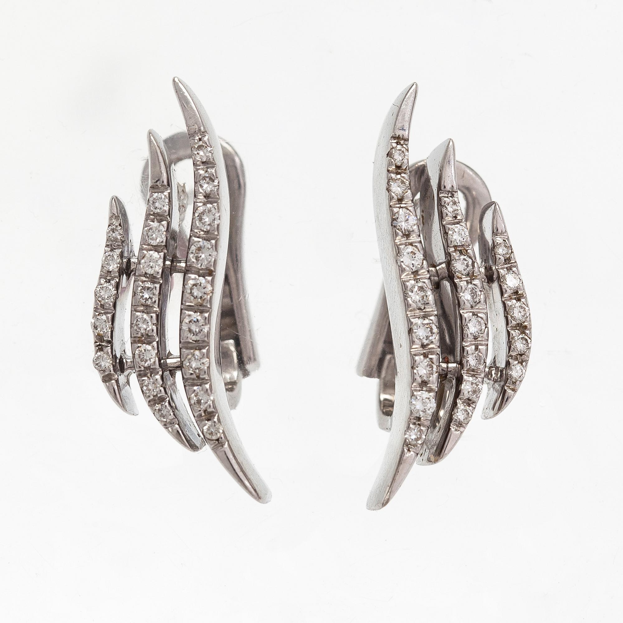 A pair of 18K white gold earrings and a ring with diamonds ca. 0.90 ct in total. Moscow.