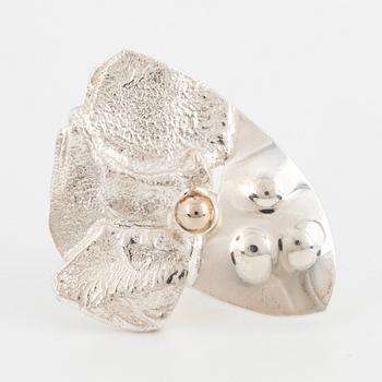 A sterling silver ring with 18K white gold detail by Rolf Karlsson.