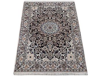 A Nain rug, part silk, 9 laa, c. 210 x 119 cm.