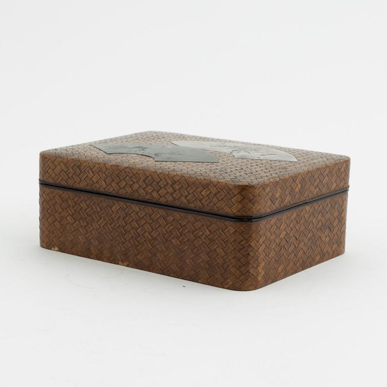 A Japanese woven bamboo box with metal inlaid shibuichi top, presumably Meji period (1868-1912).