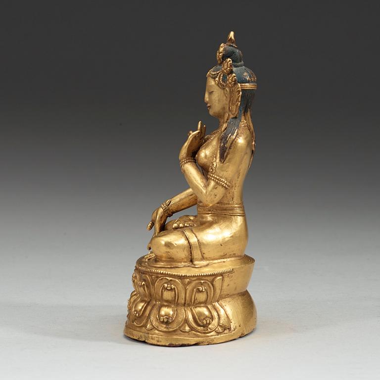 A partly gilt and painted Tibeto-Chinese bronze figure of White Tara, 18th Century.