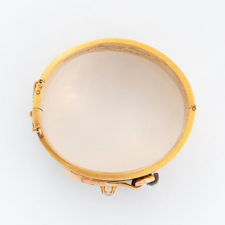 An 18K gold bangle set with old- and rose-cut diamonds.