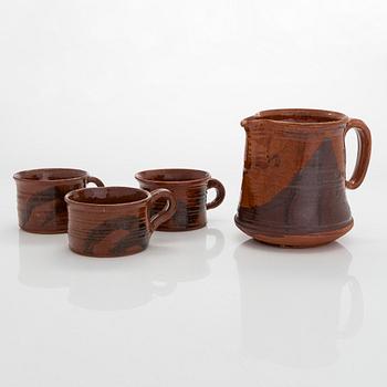 Kyllikki Salmenhaara, a red clay jug and three cups.