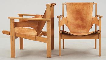A pair of Carl-Axel Acking oak and beige leather armchairs, 'Trienna', Sweden 1950's-60's.