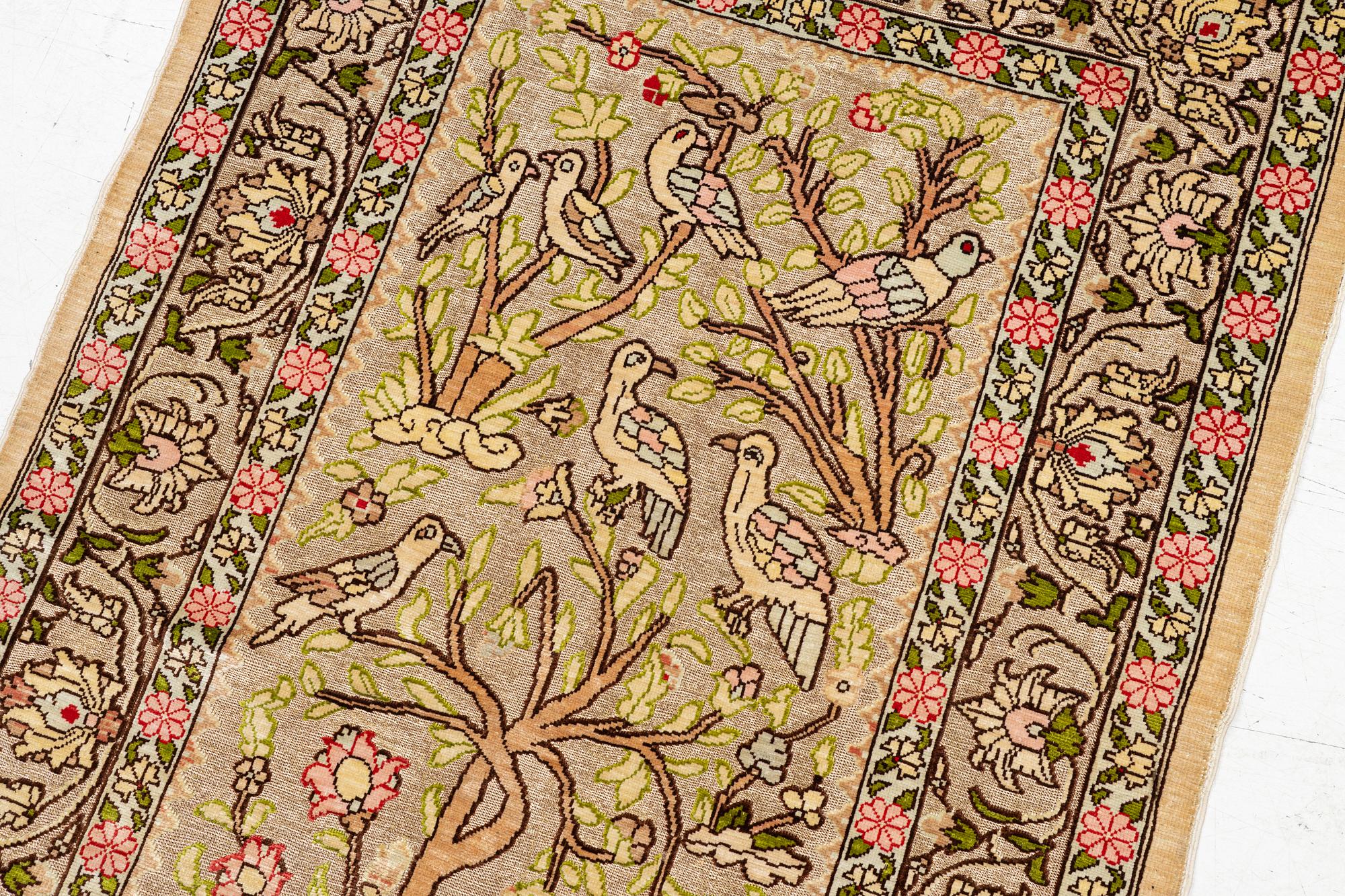 A silk an metal Hereke rug, West Anatolia, c. 100 x 68 cm.