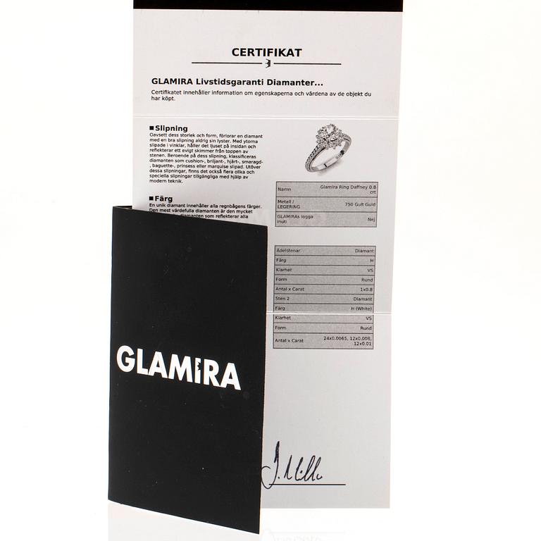 An 18K gold ring set with round brilliant-cut diamonds.