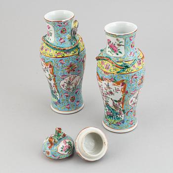 A pair of famille rose canton porcelain vases with covers, Qing dynasty, late 19th century.