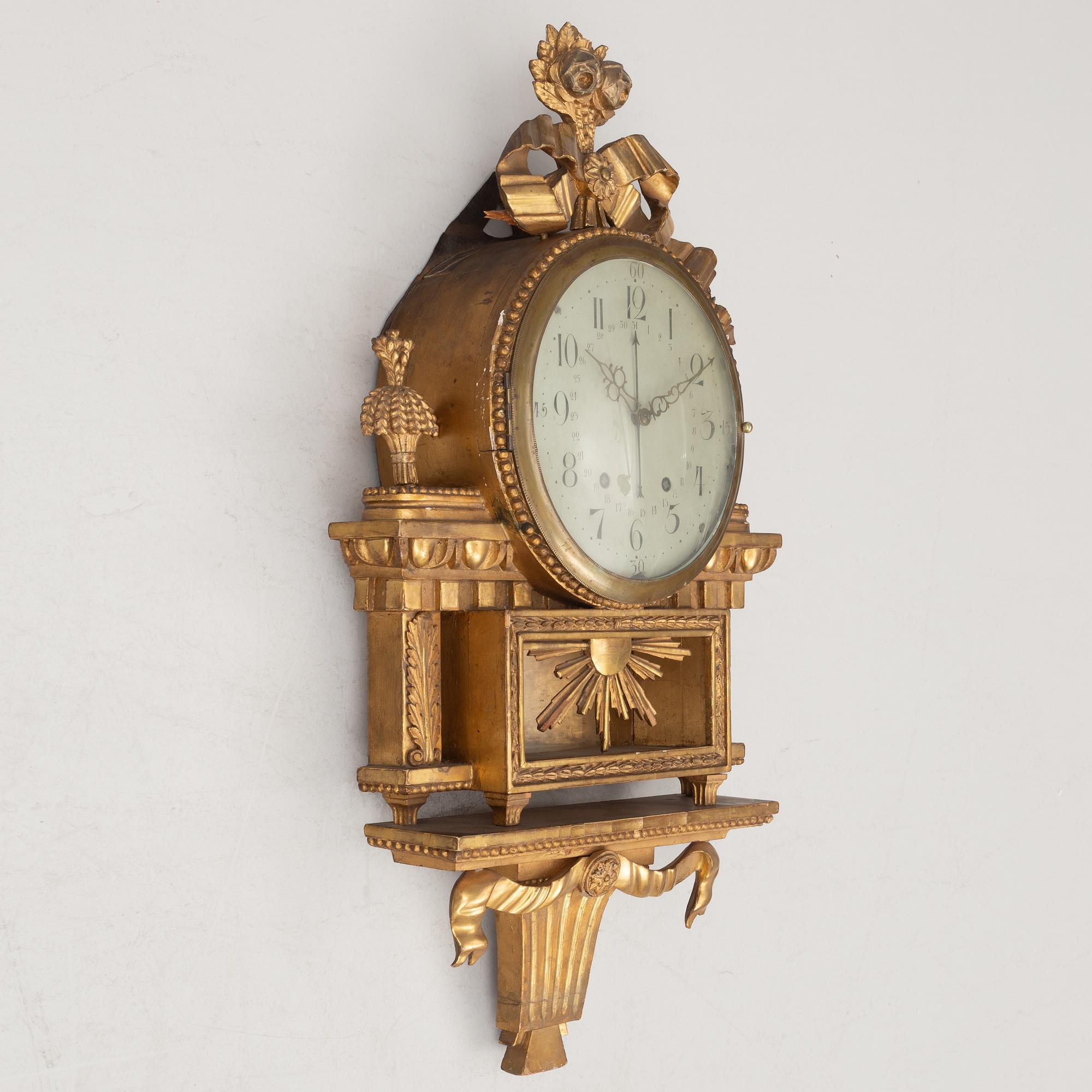 A Gustavian wall clock, late 18th century.