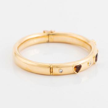 An 18K gold David Morris bangle set with citrines and round brilliant-cut diamonds.