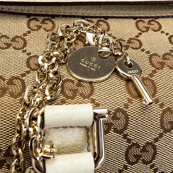 A Gucci canvas and leather hand bag.