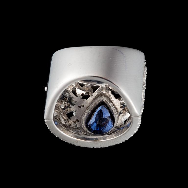 A RING, drop cut sapphire, brilliant cut diamonds, 18K white gold. .